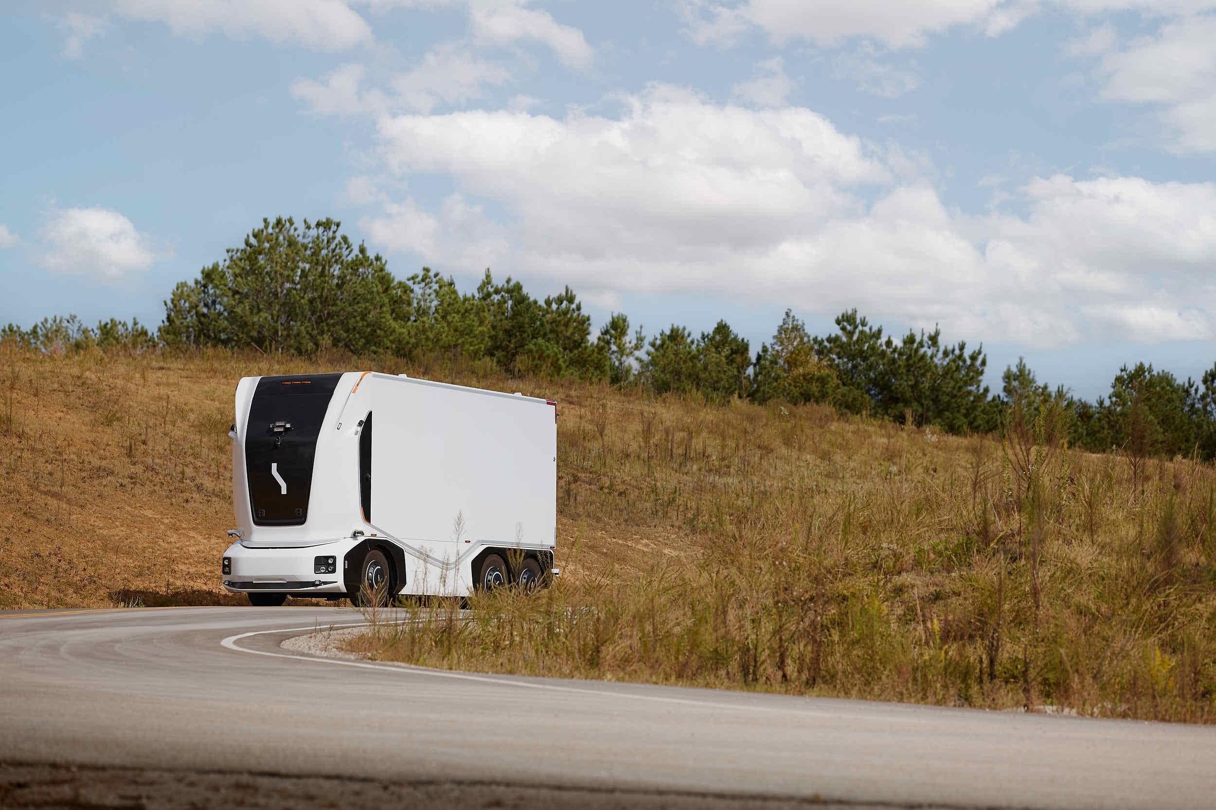 A self-driving truck, on a deserted country road.