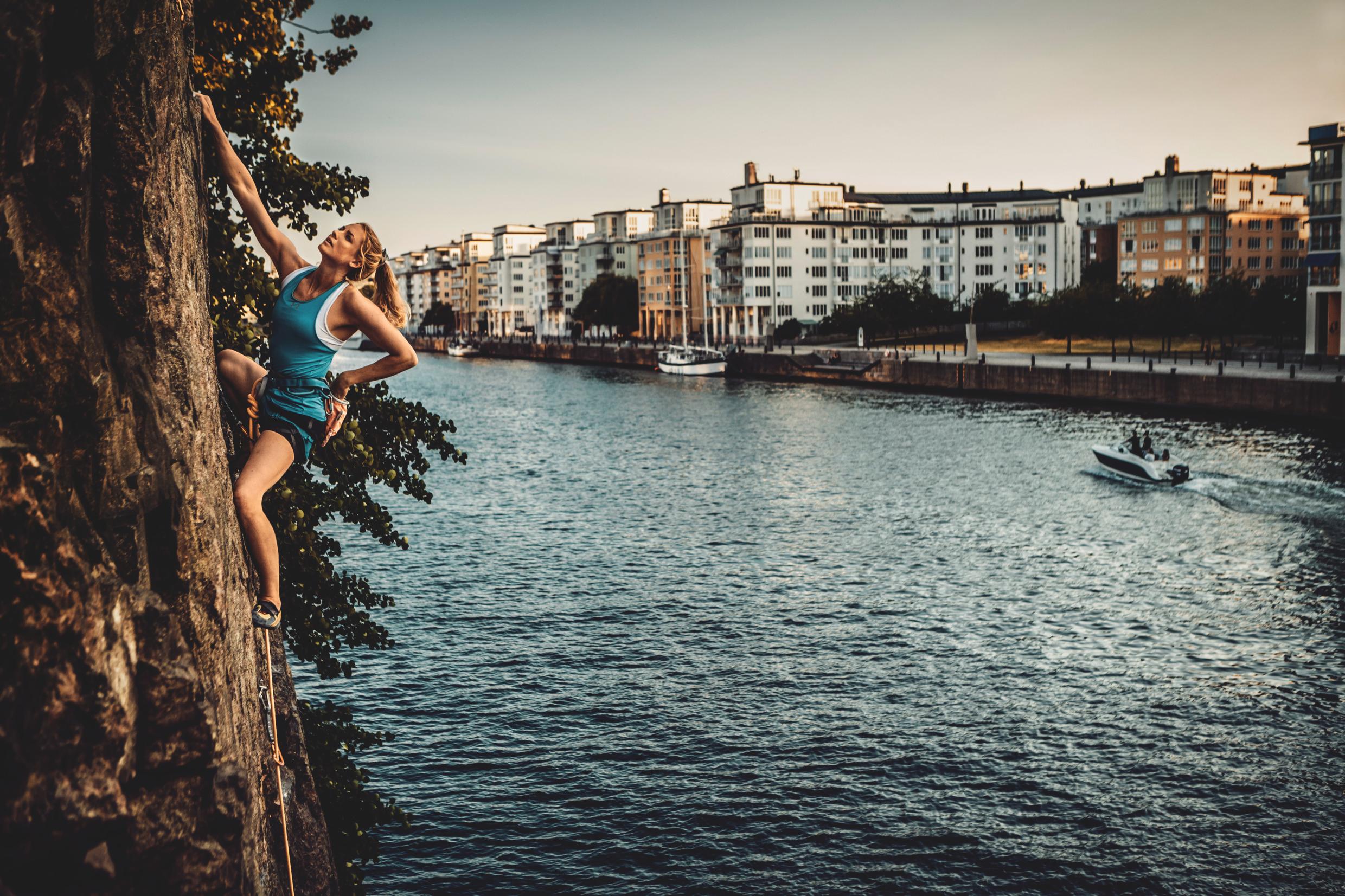 Woman climbing rocks of Södermalm in Stockholm